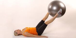 Holding the gymnastic ball between the raised legs develops the lower press